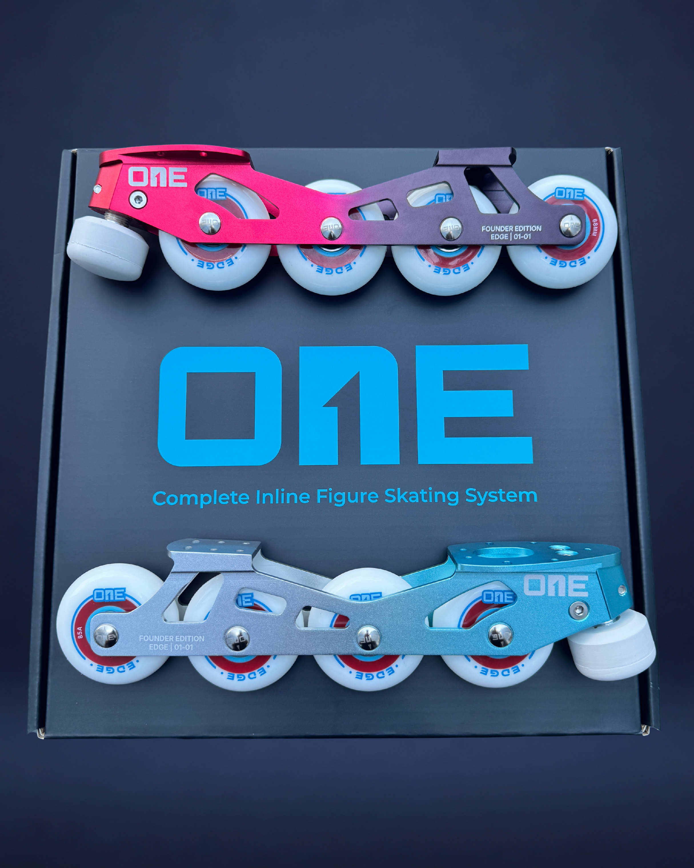 Box of 'ONE' complete inline figure skating system with Red and Cyan skates on a dark background